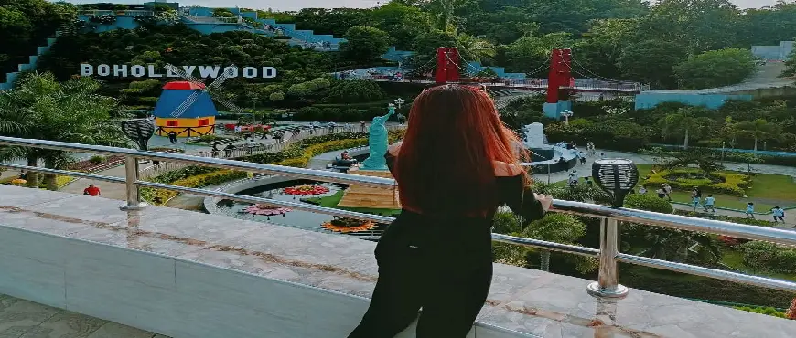 Tourists walking through the Mirror of the World attraction in Bohol with scaled-down monuments from different countries