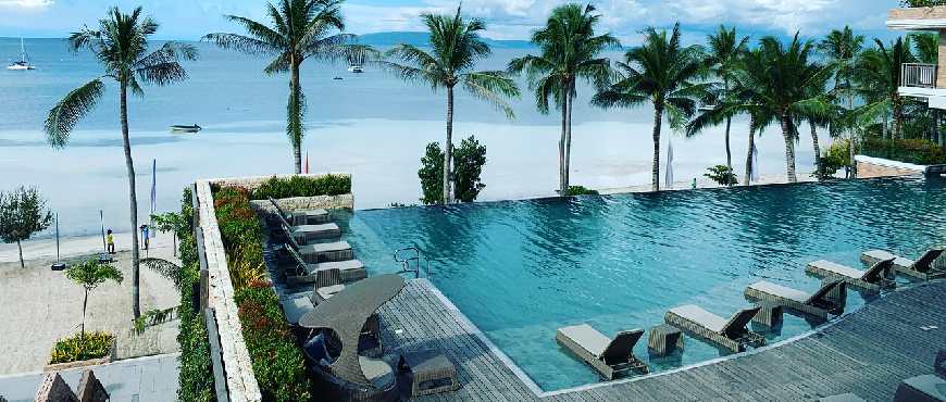 Oceanfront view of Modala Beach Resort surrounded by palm trees