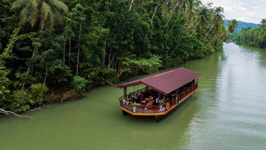 Loboc River floating restaurant in Bohol offering buffet lunch and scenic river cruise tours.